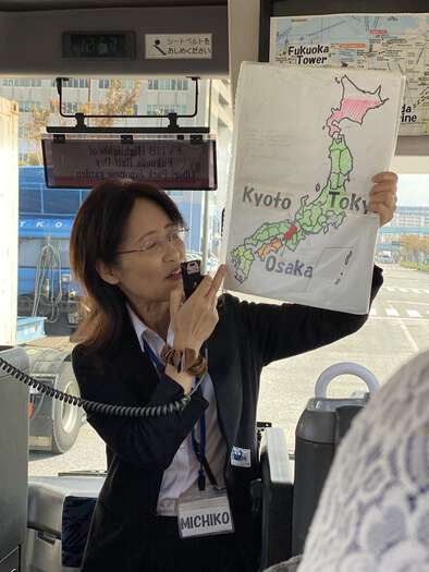 Tour guide Michiko holding up a map of our tour route
