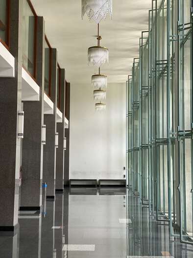 Airy glass and marble corridor in the Independence Palace