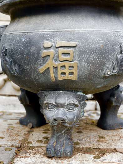 Decorated leg on one of the money pots, with a lion’s head