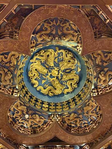 Golden dragons carved into the ceiling of the foyer