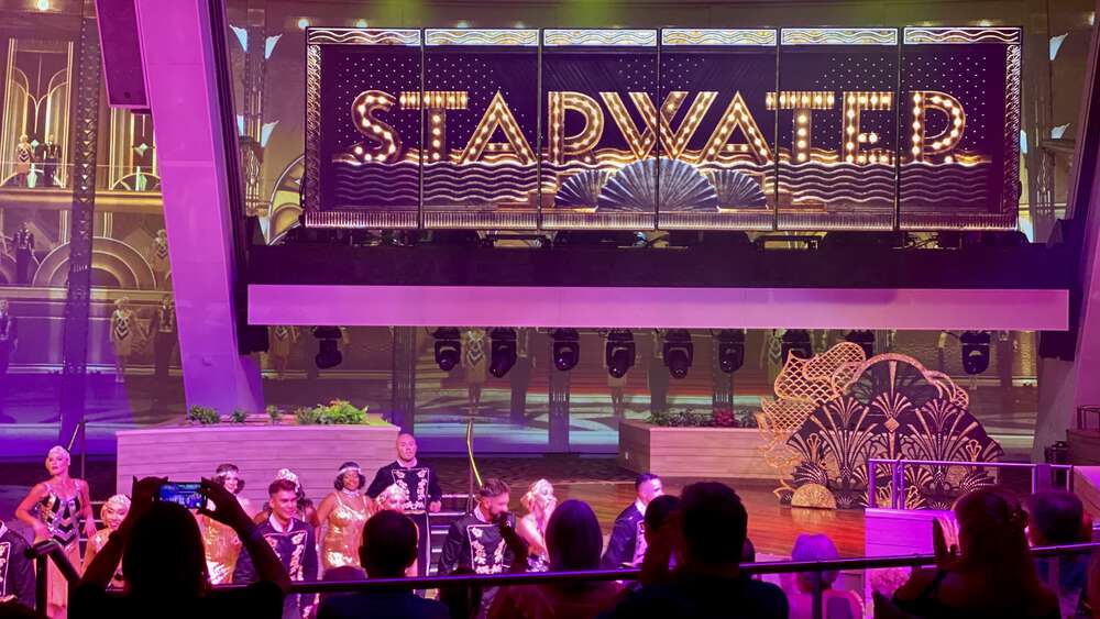 Starwater performance with dancers in 1920s costumes in front of a big Starwater logo