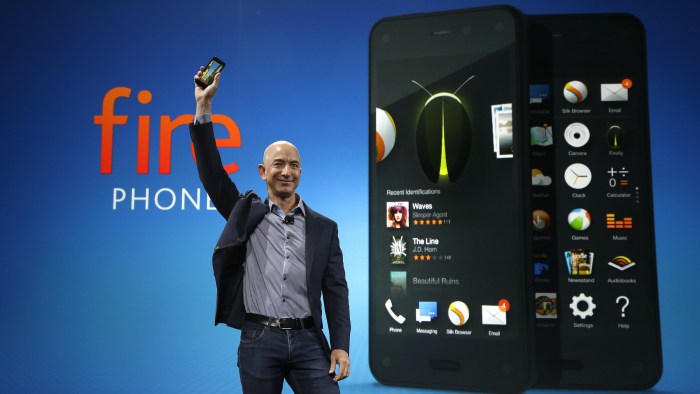 Jeff Bezos holding up an Amazon Fire Phone